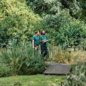 2 men wearing green shirt