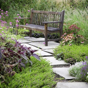 a wooden bench in a garden