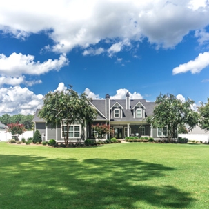 a house with wide and green lawn