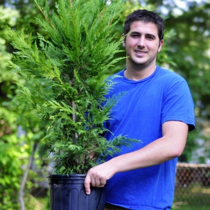 a man holding a plant in a pot