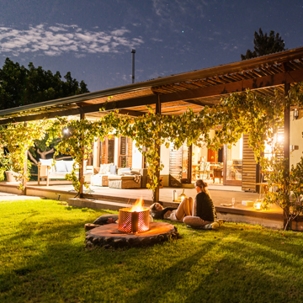 a lady sitting on her lawn with bonfire