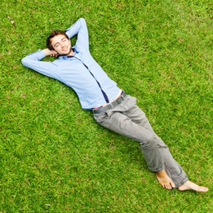 A man laying on a lawn