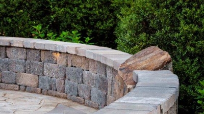 Curved gray and brown stone wall. Photo