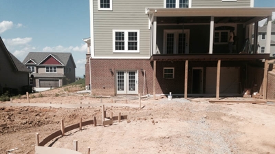 Backyard patio construction; curved pool forms in place. Photo
