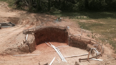 Pool excavation with plumbing and support structures. Photo