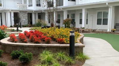 Walkway with colorful plantings and buildings Photo