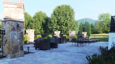 An outdoor patio area with stone walls and paver stones. Photo