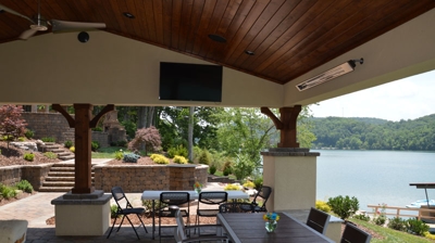 Lakefront patio with furniture and landscaping. Photo