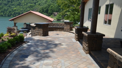 patio area with curved stone walls, stone column with pillars Photo