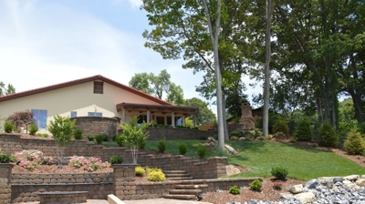 Stone walls, small stone fire pit, pathway of rocks surrounding stone steps leading back to the house. Photo
