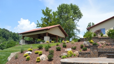 Stone wall with stone steps surrounded by rocks and dyed brown mulch Photo
