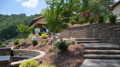 A landscaped area with stone steps and plantings. Photo