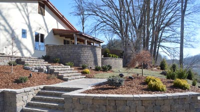 stone walls alongside stone steps leading to the back of a house Photo