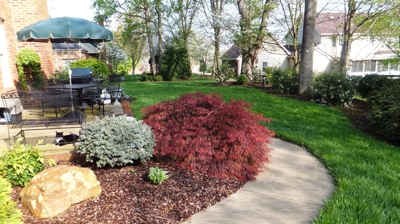 Garden path with landscaping, patio and furniture Photo