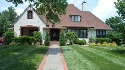 A house with a lawn and walkway. Photo