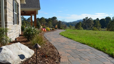 Paved walkway to grassy field Photo