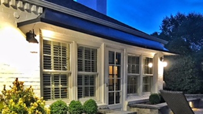 backyard with stone flooring, stone walls and a lawn chair Photo