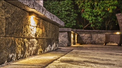 close up of the paved patio with lights in the stone walls Photo